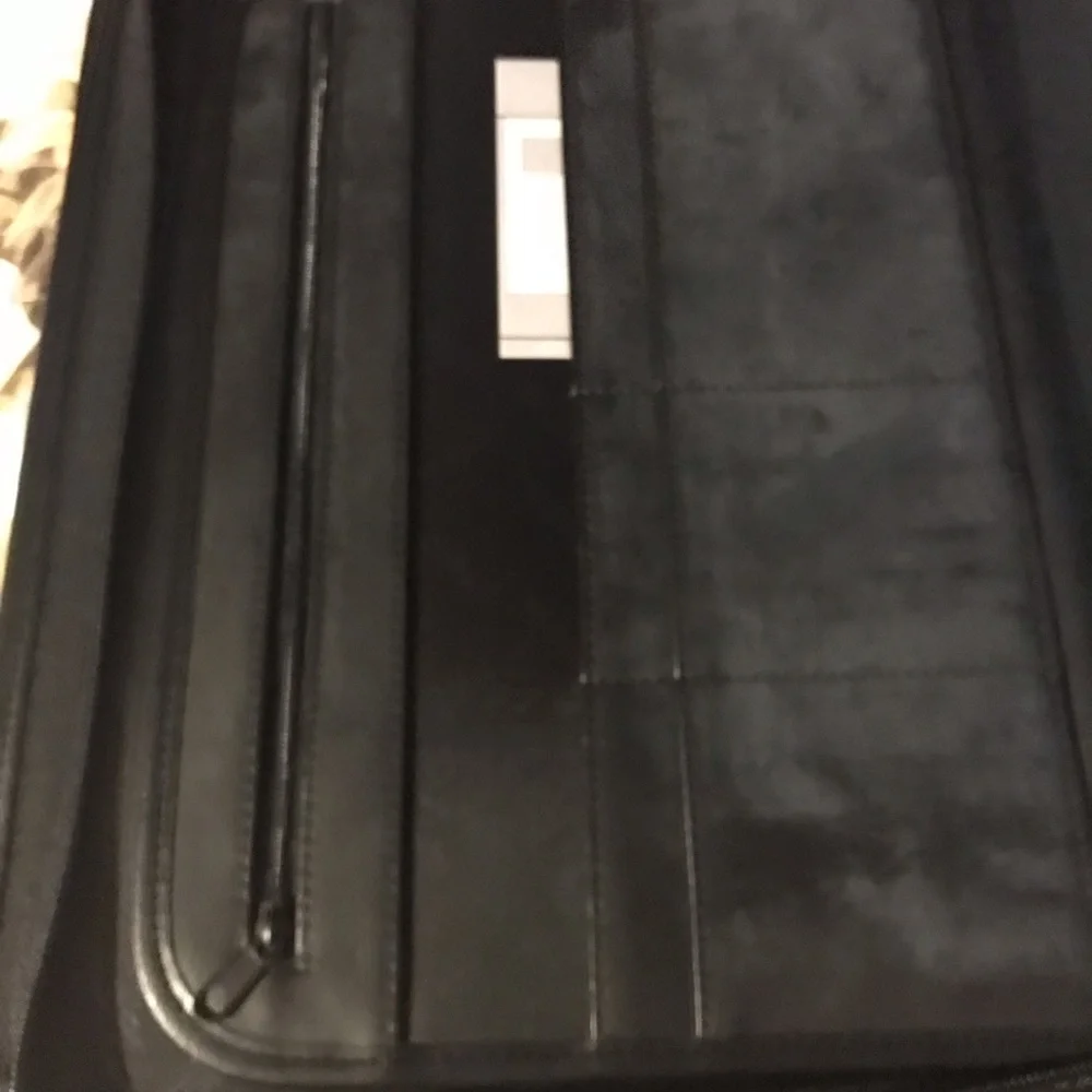 Black portfolio with wraparound zipper. Writing pad, slide and zippered pockets.